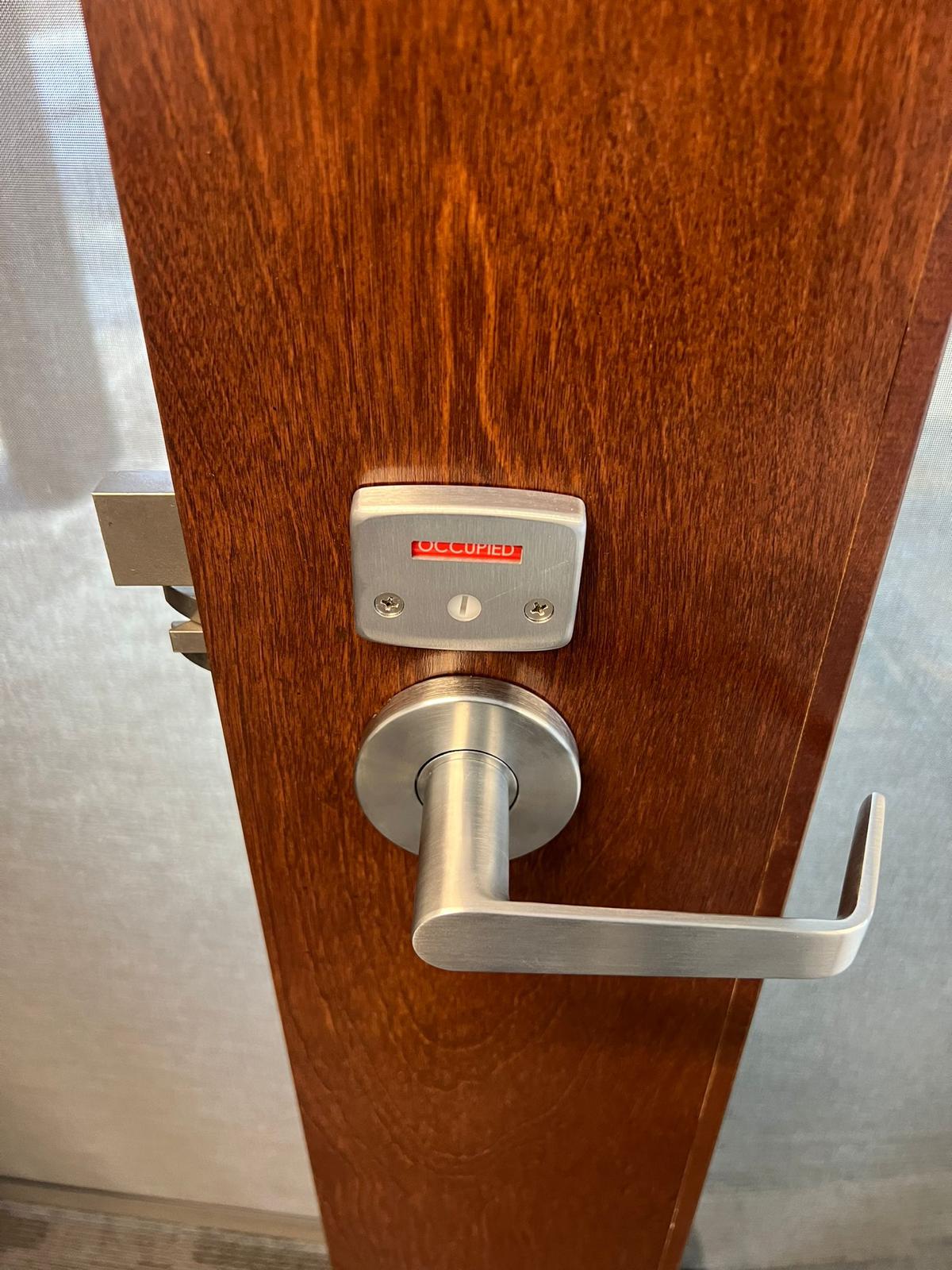 Commercial Install Hardware Commercial lever handle with the privacy indicator showing occupied