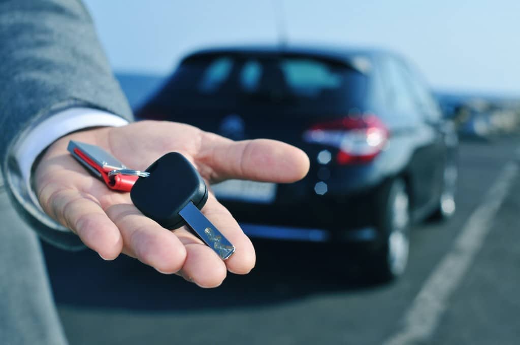 man holding a car key