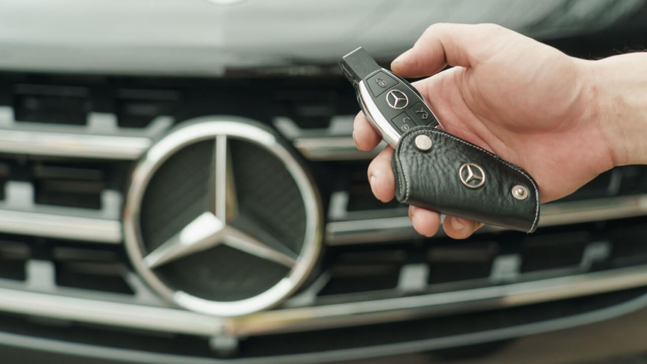 Mercedes car key in front of the vehicle