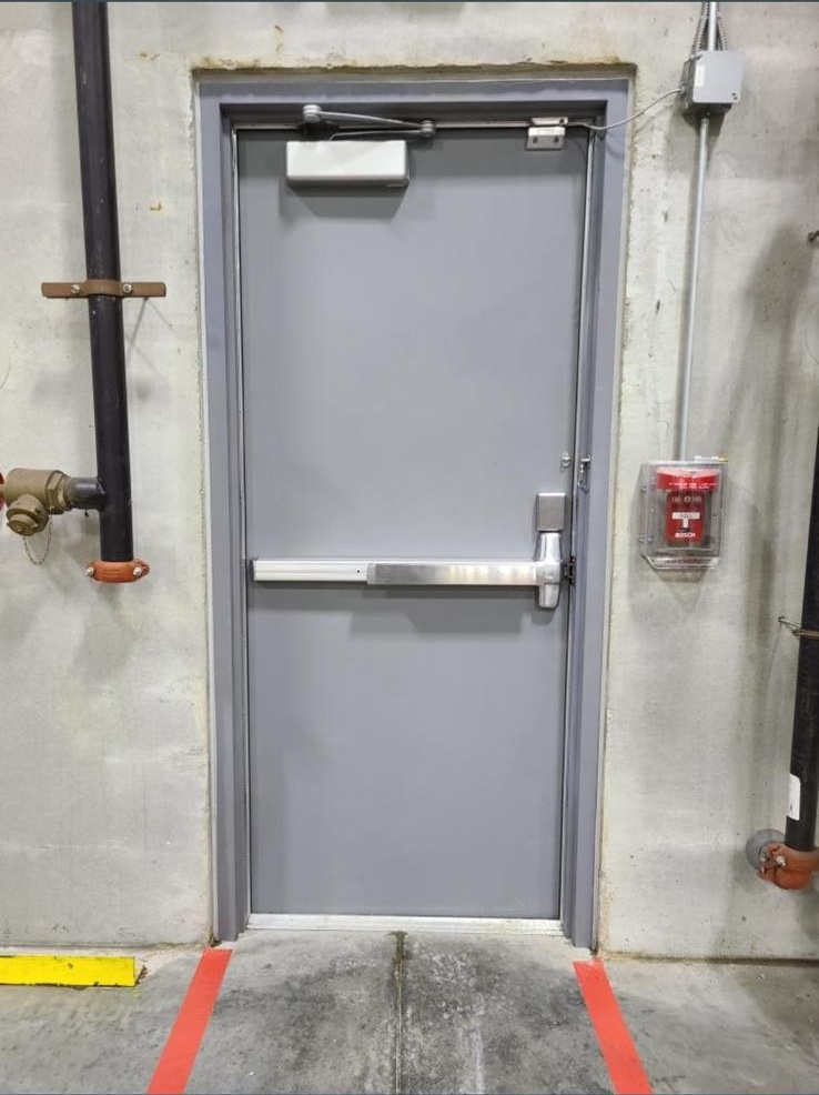 Commercial Install Hardware Panic bar exit device installed on a commercial emergency exit door