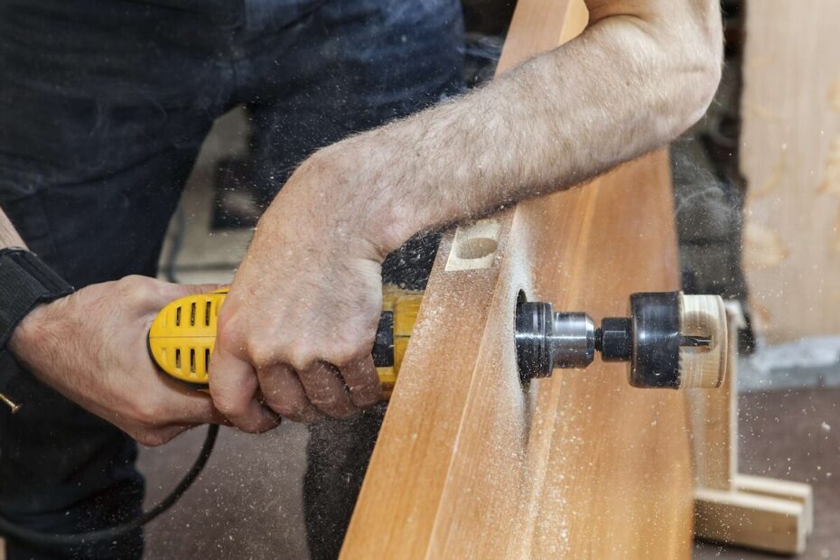 Residential locksmith drilling hole in the door for the lock