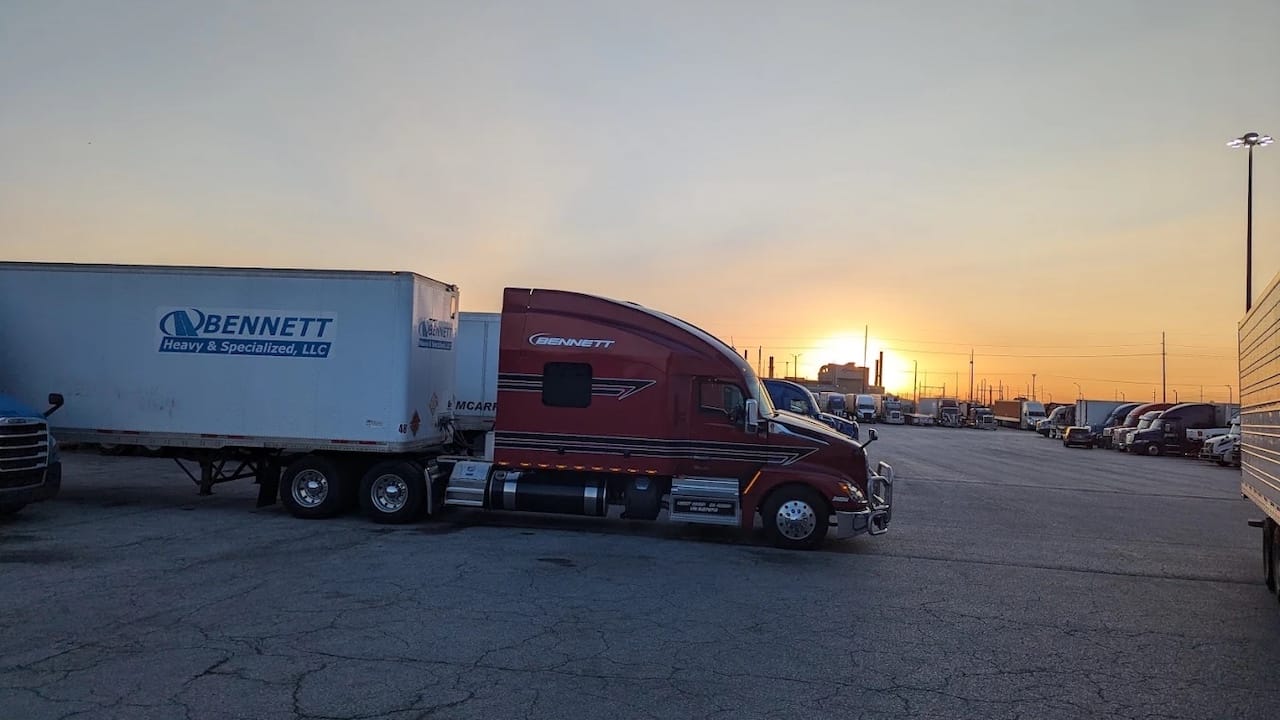 Red semi truck parked at an Indianapolis area truck stop at night