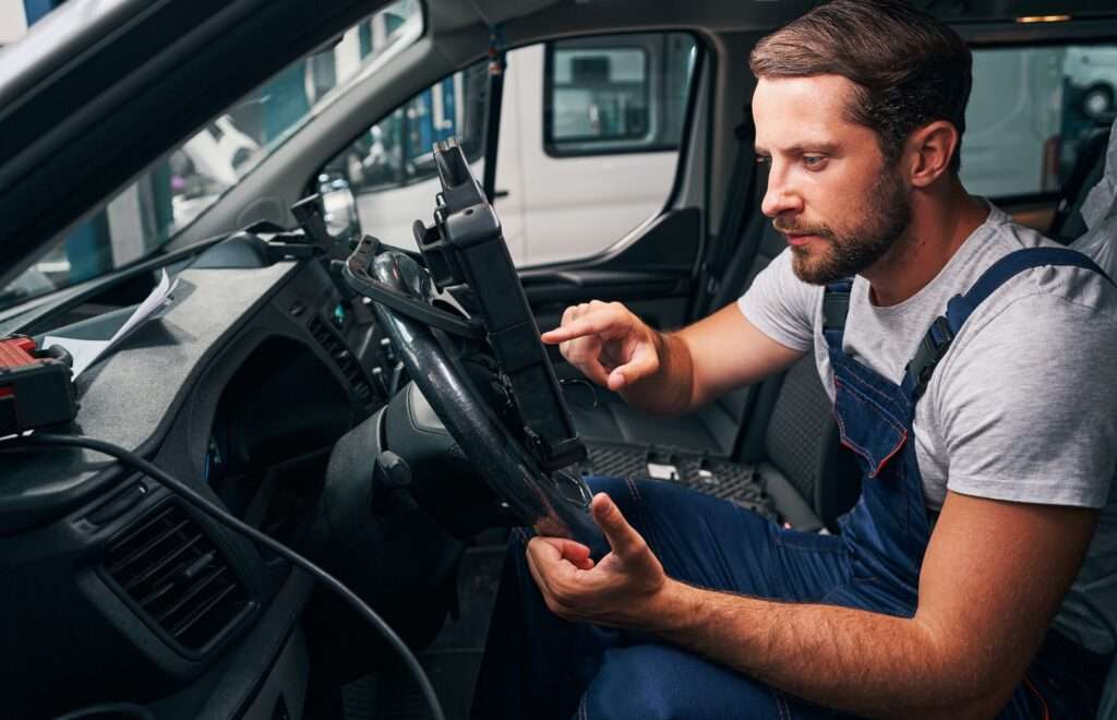 Automotive locksmith is scanning car settings